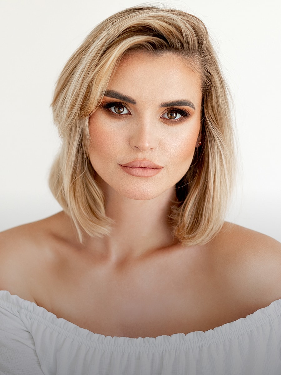 Woman with blonde hair and natural makeup.