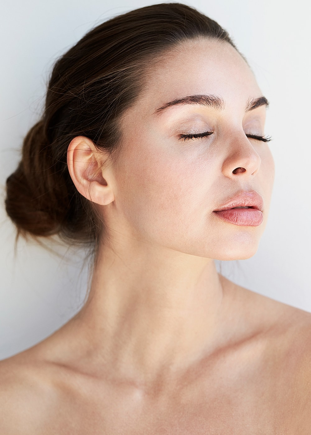 Woman with closed eyes, serene expression, natural beauty.
