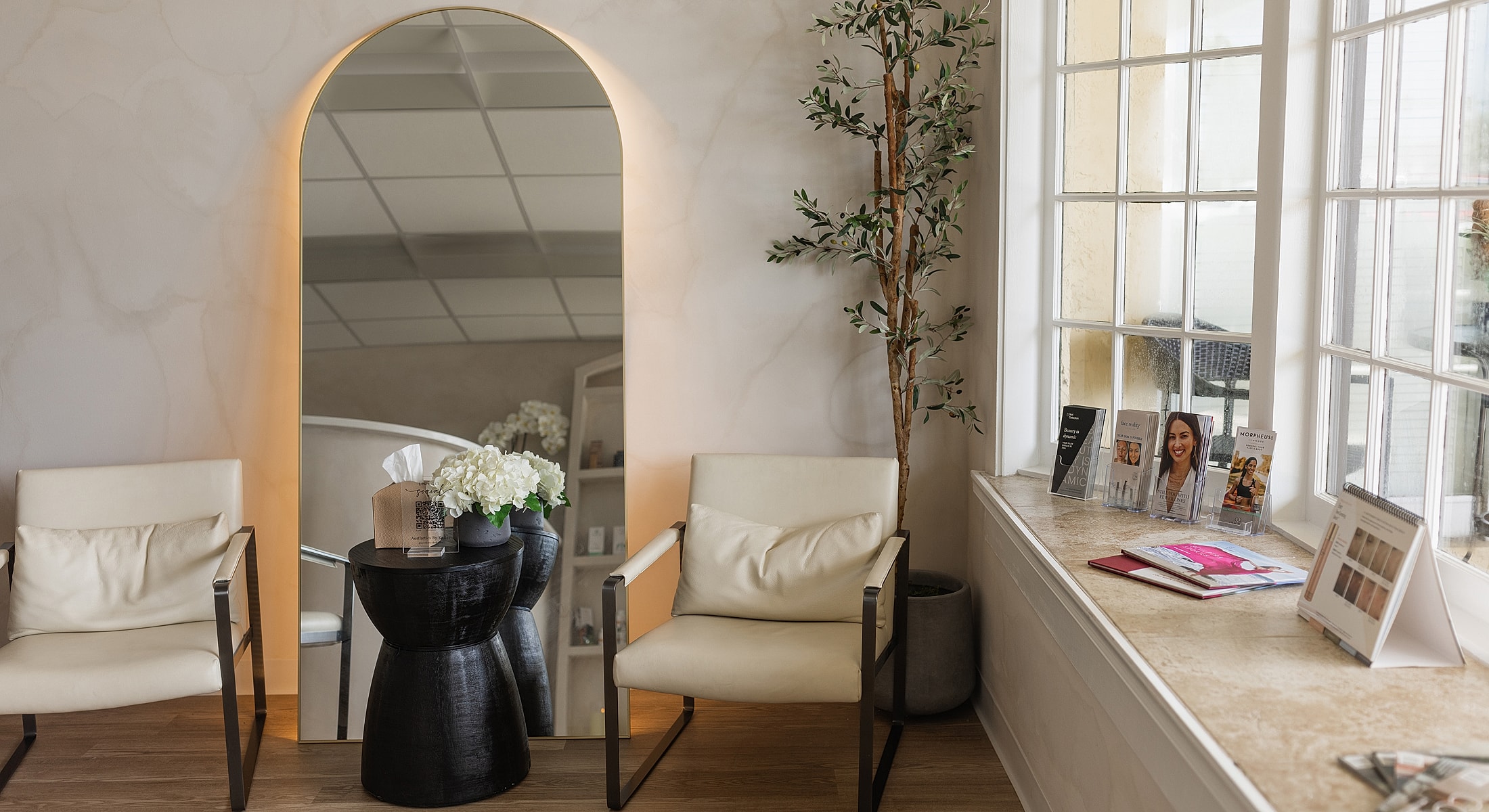 Modern waiting room with elegant decor and plants.
