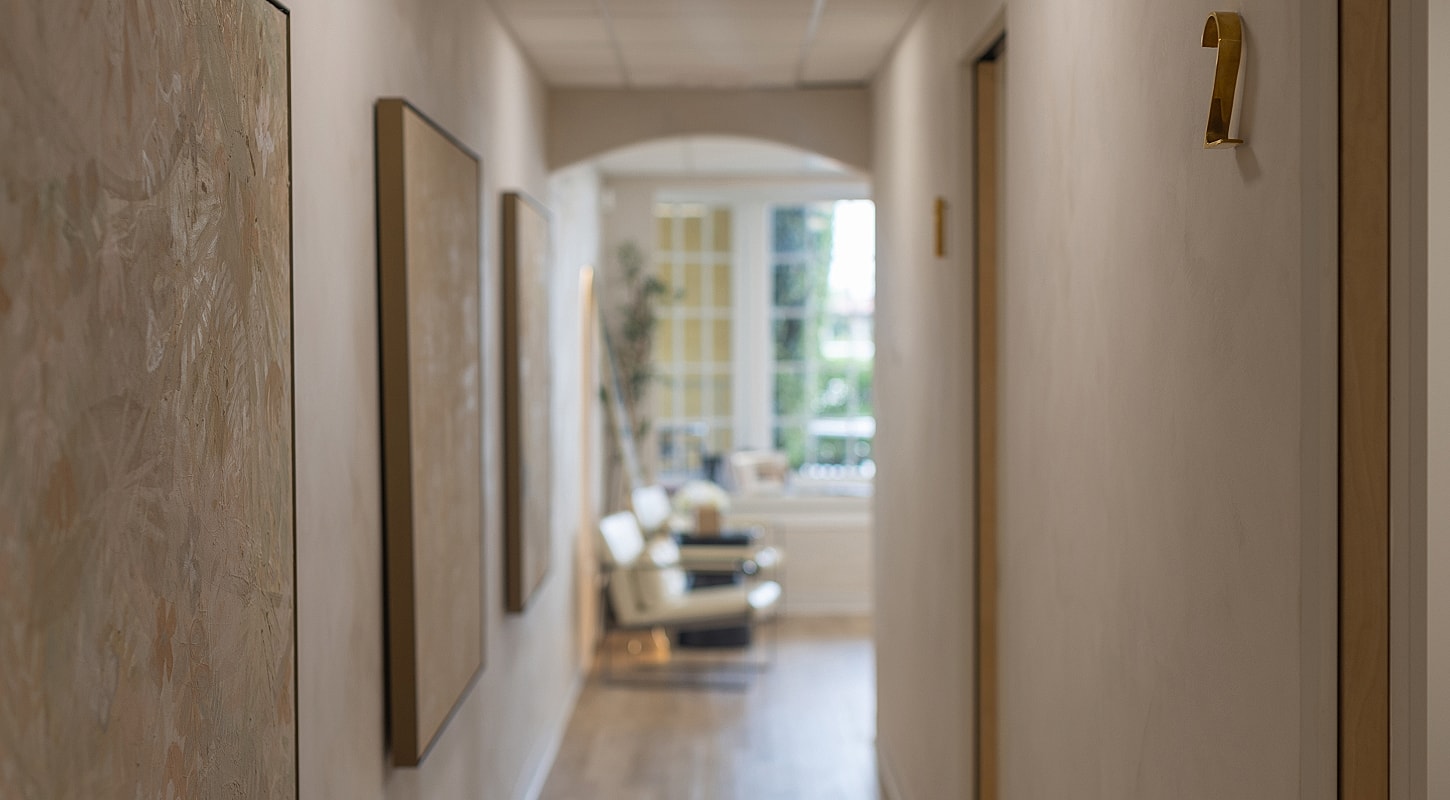 Hallway with art and number two door.